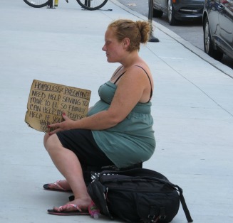 unemployed woman begs on street-unemployment